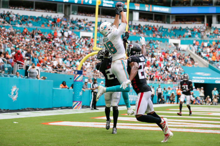 Oct 24, 2021; Miami Gardens, Florida, USA; Miami Dolphins tight end Mike Gesicki (88) makes a catch over Atlanta Falcons cornerback Fabian Moreau (22) and safety Richie Grant (27) for a touchdown in the third quarter of the game at Hard Rock Stadium. Mandatory Credit: Sam Navarro-USA TODAY Sports